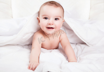 生活搞笑摄影照片_可爱又搞笑的小宝宝微笑下白色的毯子。水疗中心副本