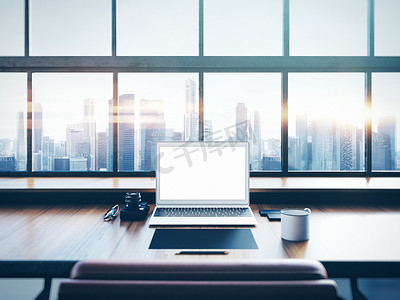 panoramic摄影照片_Photo of laptop on the worksplace with panoramic windows.  City at sunrise in a background. 3D rendering