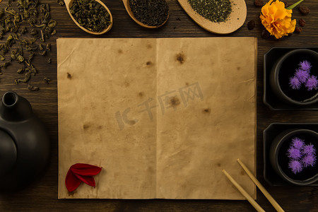 dried摄影照片_black, Oolong in a spoon, dried apples on the old blank open book on wooden background. Menu, recipe, mock up