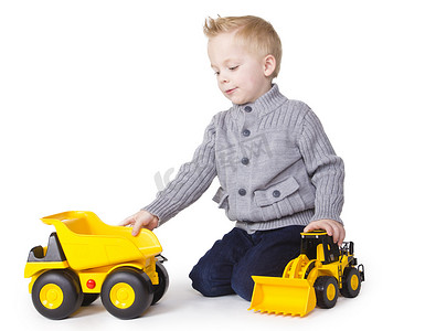 儿童的想象力摄影照片_可爱的男孩玩玩具卡车
