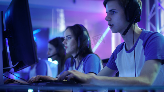 团队的专业电子竞技玩家玩网络游戏锦标赛竞争视频游戏中。他们彼此交流到麦克风.