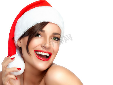 圣诞快乐女孩在圣诞老人的帽子。美丽的笑容