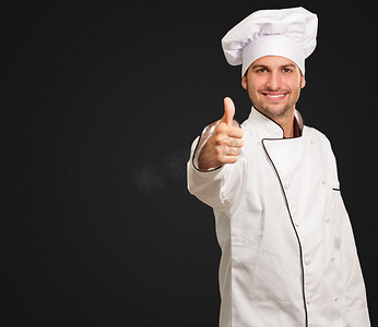 厨师餐厅摄影照片_显示标志竖起大拇指的男厨师αρσενικό σεφ δείχνει μπράβο σημάδι