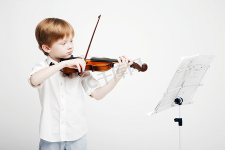 小可爱的红发男孩，用他手中的小提琴