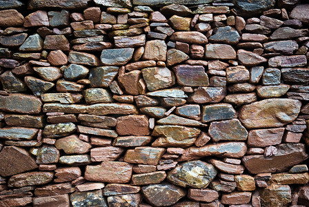 风化岩摄影照片_仿古石头砌的墙