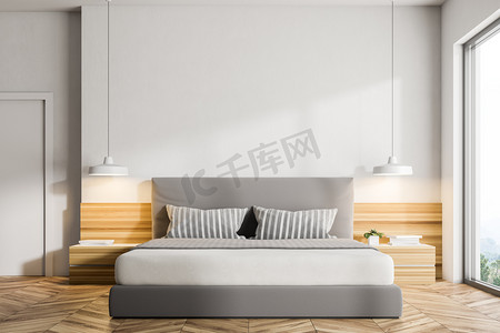 现代卧室的内部有白色的墙壁, 一层木地板, 一张双人床和两个床头台灯。阁楼窗口。3d 渲染模拟