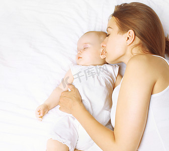 舒适睡眠摄影照片_妈妈和宝宝在家里的床上睡觉