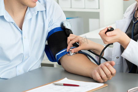 Female medicine doctor hands measuring blood pressure