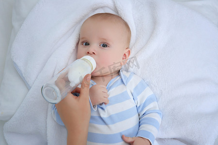 Mother feeding baby from bottle