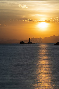 夕阳海洋里的灯塔摄影图配图