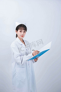 女医护人员摄影照片_护士白天医护人员医院写病历摄影图配图