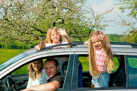休假摄影照片_带着孩子在车里的家庭