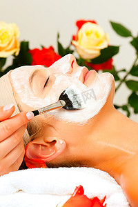 掩面摄影照片_在美容或健康治疗过程中使用面膜或面霜的女性