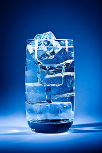一键上传摄影照片_深蓝色背景上的一杯加冰的水