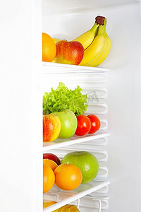 冰箱里的水果摄影照片_白色冰箱里的新鲜蔬菜和水果