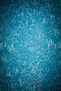灰白背景摄影照片_霜图案在玻璃上的蓝色背景