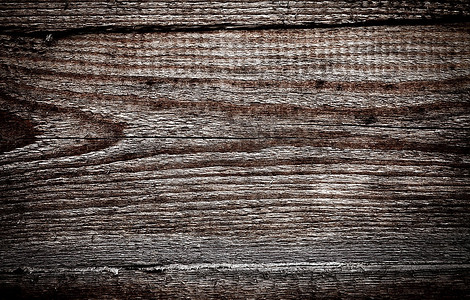 暗色鳖精摄影照片_污迹斑斑的旧木板。暗色背景