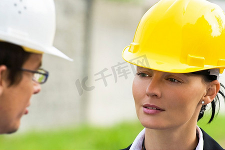 年轻的男性和女性经理在工业环境中一起工作