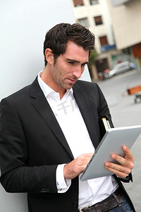 免费无线上网摄影照片_镇上一名男子用电子平板电脑上网