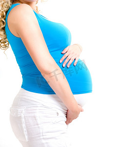 大肚子摄影照片_孕妇露出她的大肚子，被隔离在白色上