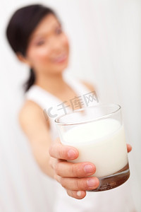 亚裔中国女孩对着镜头拿着一杯牛奶