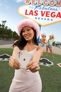 美国内华达州拉斯维加斯欢迎标语前拿着卡片的妇女