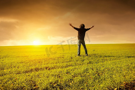 绿色田野中的人举起双手，为幸福生活而努力