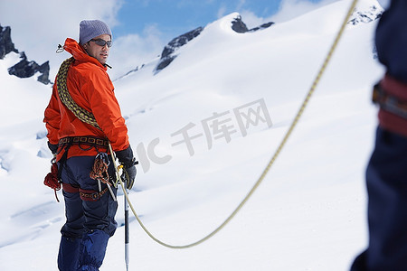 雪山中的徒步旅行者通过安全线加入