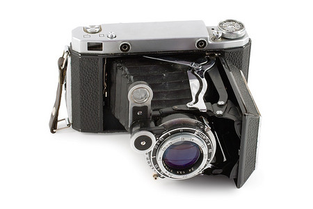 摄象机摄影照片_白色背景隔离的旧折叠式相机