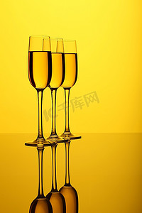 鹿酒摄影照片_彩色背景上有酒的玻璃杯