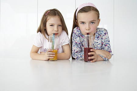 两个女孩喝着水果冰激凌