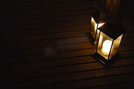 两个灯笼摄影照片_夜间甲板上的两个发光的灯笼