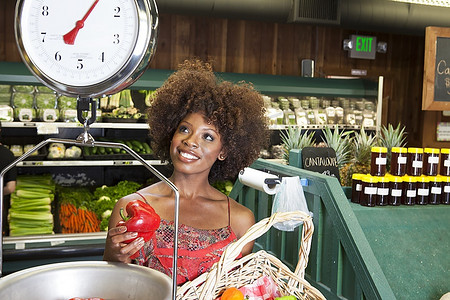 非洲裔美国妇女在超市秤重甜椒