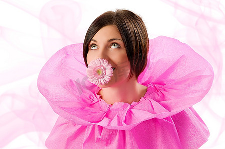 有趣的照片，一个年轻漂亮的女孩用粉色领纸抬头看着，嘴里叼着一朵花
