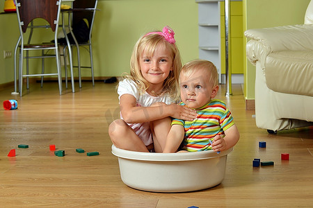 小男孩和他的妹妹坐在浴缸里