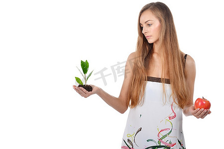 美丽的年轻女子抱着绿色的树芽和苹果