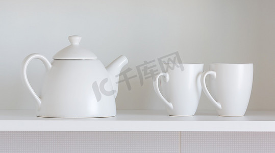 架子上的白色茶壶和杯子