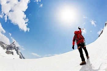 一名男性登山者表达了他的喜悦登上了一座积雪的山峰。勃朗峰，法国。
