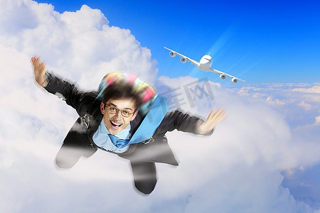 gif动态图动漫摄影照片_青年商人背着降落伞飞行的概念形象