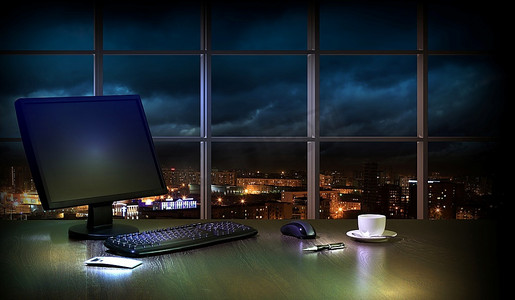 窗户的景色摄影照片_晚上在办公室工作，从窗户可以看到城市的景色