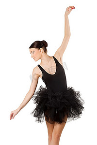 优雅的芭蕾舞演员在黑色芭蕾舞裙采取古典舞蹈姿势向下看