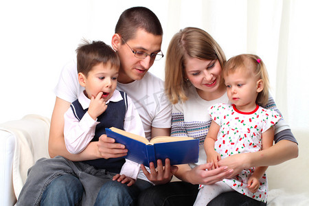 读一本书在沙发上的幸福家庭