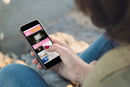 Woman touch the screen of her smartphone to watch movies