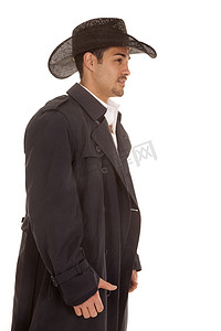 勇敢点摄影照片_cowboy in coat side view hat