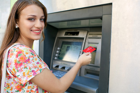 Woman using a cash point machine