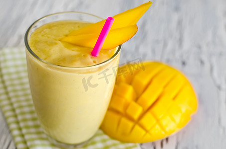 奶昔饮品摄影照片_健康的早餐的黄色的芒果酸奶奶昔