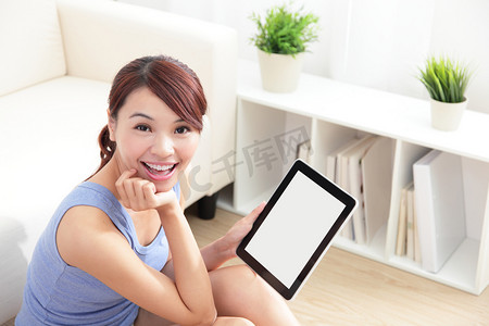 快乐的女人在沙发上使用 tablet pc