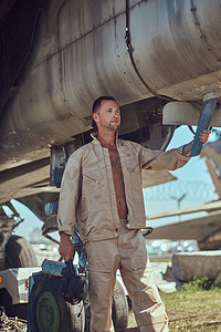 飞行员在一个露天博物馆的战斗战斗机拦截器附近站立的制服.
