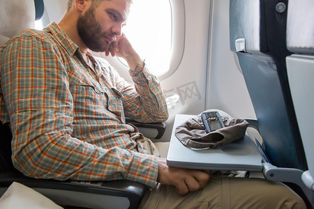 passenger摄影照片_Tired Traveler at Airplane Passenger Chair