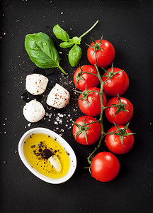 cheese摄影照片_Cherry tomatoes, mozzarella cheese, basil and olive oil